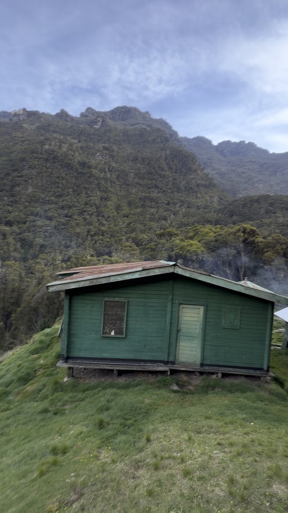 Green camp huts in a mountain valley